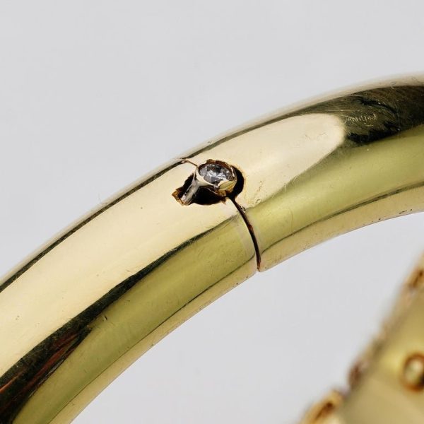 Ruby and diamond bangle in 14 carat gold.