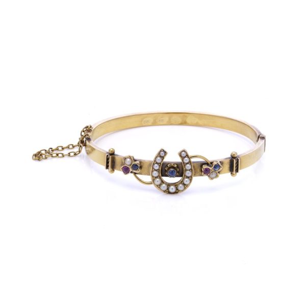Victorian gold bangle with gemstones.