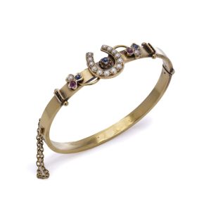 Victorian gold bangle with gemstones.