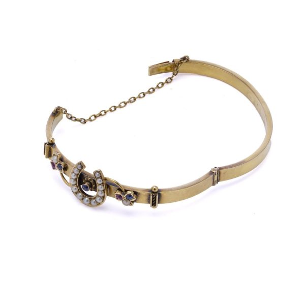 Victorian gold bangle with gemstones.