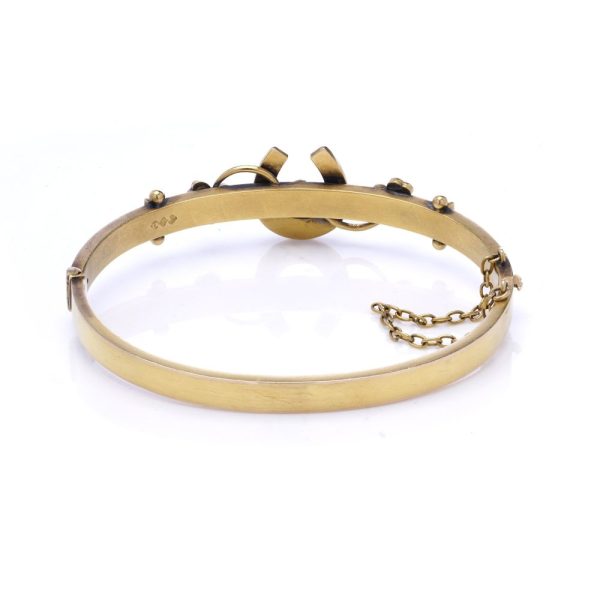 Victorian gold bangle with gemstones.