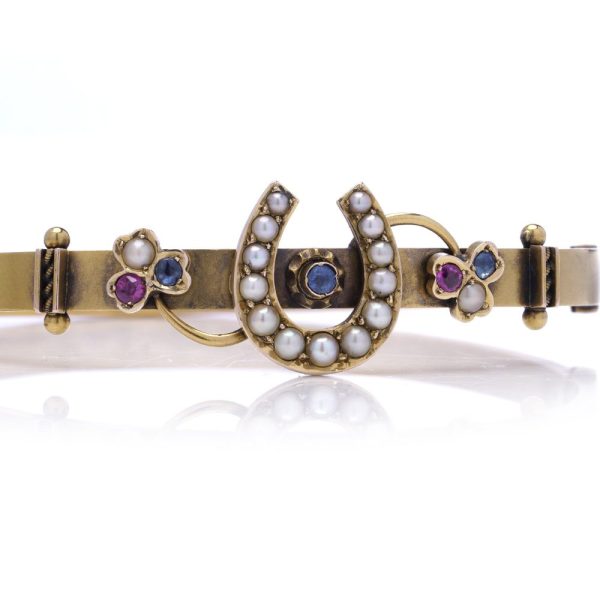 Victorian gold bangle with gemstones.
