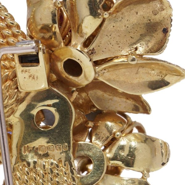 Diamond and gemstone brooch in gold.