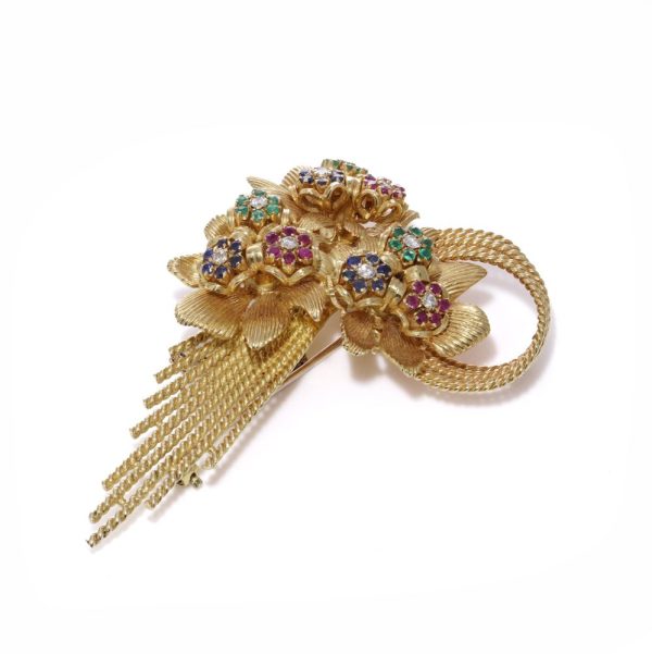 Diamond and gemstone brooch in gold.
