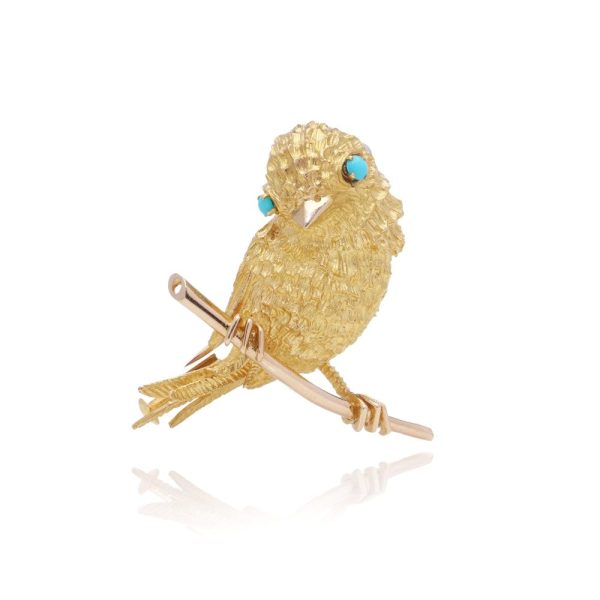 Vintage gold bird brooch with turquoise eyes.