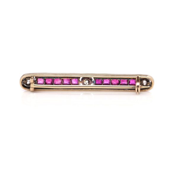 Antique ruby and diamond bar brooch in gold and silver.