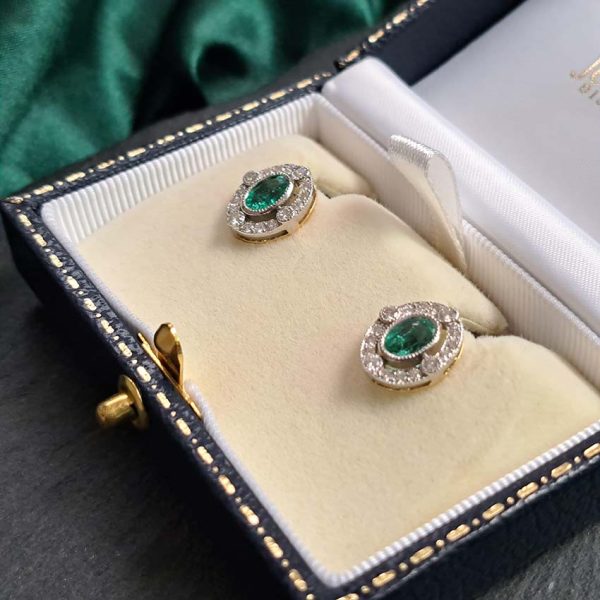 Contemporary Emerald and Diamond Oval Cluster Stud Earrings, 1.55ct emeralds with fixed border of diamonds with four focal at compass points in 18ct gold