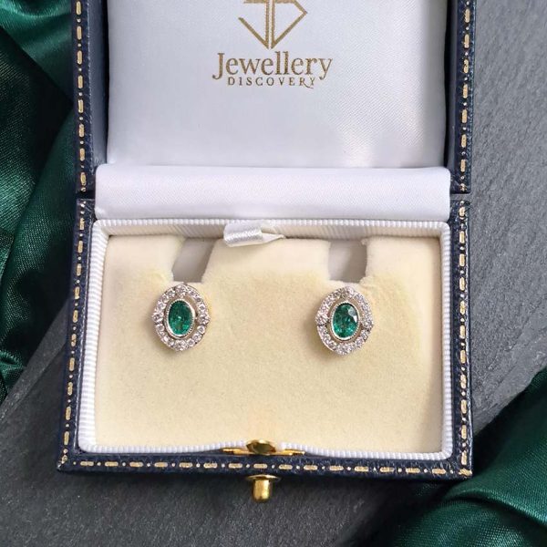 Contemporary Emerald and Diamond Oval Cluster Stud Earrings, 1.55ct emeralds with fixed border of diamonds with four focal at compass points in 18ct gold