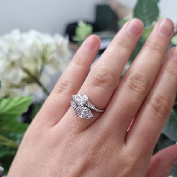 Art Deco Pear Diamond Toi et Moi Crossover Engagement Ring in Platinum, antique diamond two stone ring, Two pear-shaped old cut diamonds lead to tapered baguette diamonds