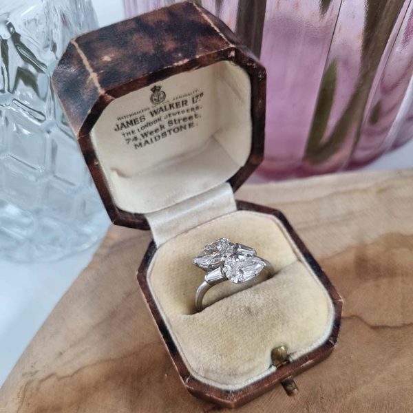 Art Deco Pear Diamond Toi et Moi Crossover Engagement Ring in Platinum, antique diamond two stone ring, Two pear-shaped old cut diamonds lead to tapered baguette diamonds