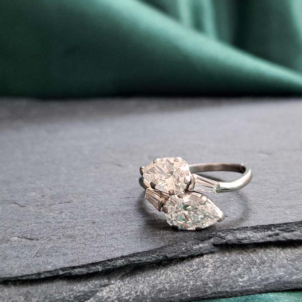 Art Deco Pear Diamond Toi et Moi Crossover Engagement Ring in Platinum, antique diamond two stone ring, Two pear-shaped old cut diamonds lead to tapered baguette diamonds