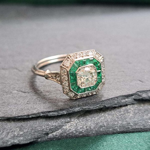 Old Cut Diamond and Emerald Target Cluster Engagement Ring, 0.55ct old cut diamond surrounded by calibre emeralds and an outer row of diamonds in platinum