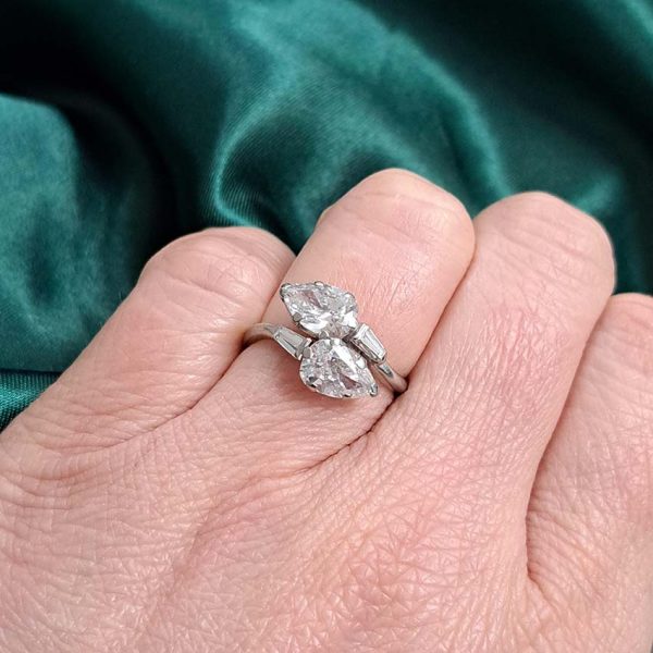 Art Deco Pear Diamond Toi et Moi Crossover Engagement Ring in Platinum, antique diamond two stone ring, Two pear-shaped diamonds lead to tapered baguette diamonds
