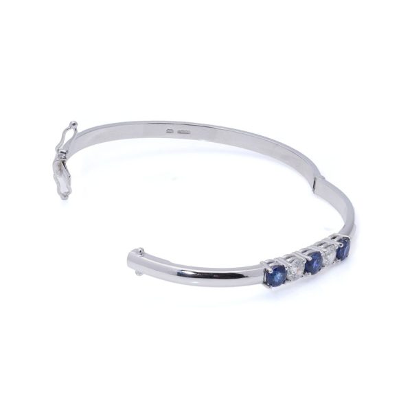 Platinum bangle with sapphires and diamonds.
