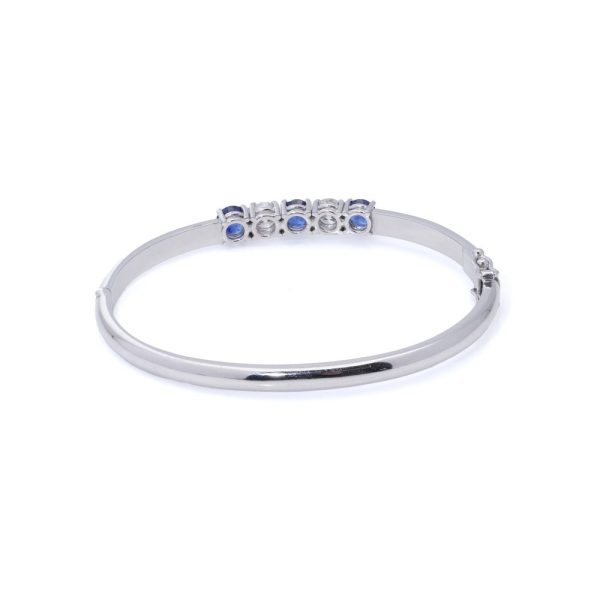 Platinum bangle with sapphires and diamonds.