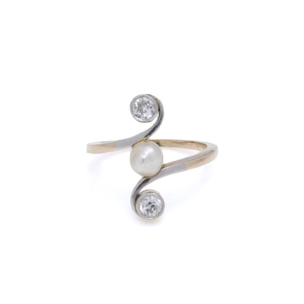Antique pearl and diamond three stone ring in gold.