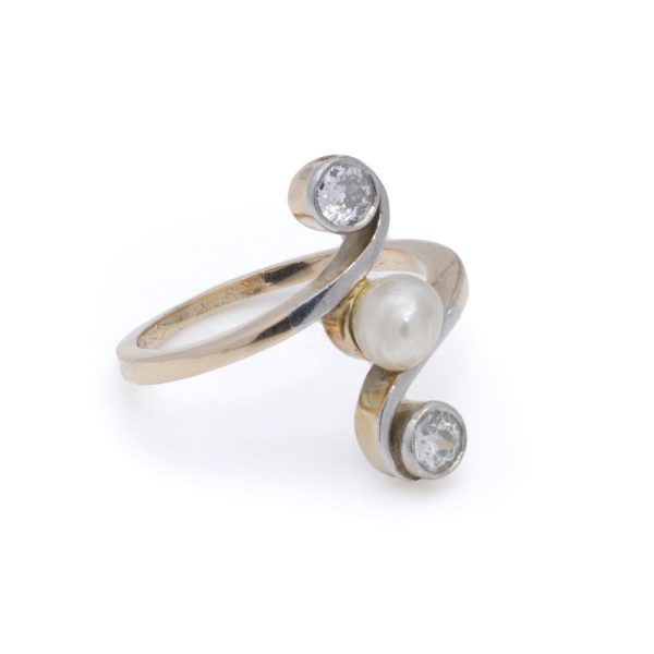 Antique pearl and diamond three stone ring in gold.