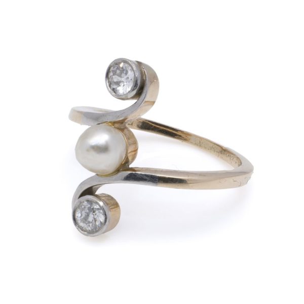 Antique pearl and diamond three stone ring in gold.