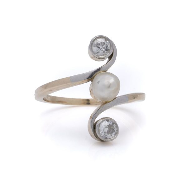 Antique pearl and diamond three stone ring in gold.