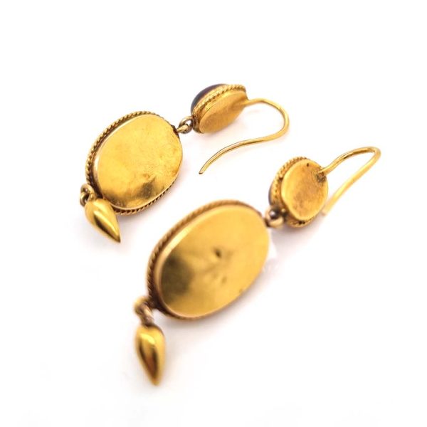 Victorian Antique Garnet and Diamond Drop Earrings, oval cabochon garnets suspend larger oval garnets with rose cut diamonds set to central stars in 18ct yellow gold with twisted gold wire surrounds and gold conical tear drops. Late 19th century Circa 1870