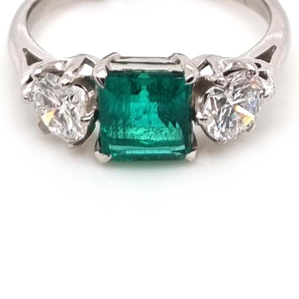 Art Deco Colombian Emerald and Diamond Trilogy Three Stone Engagement Ring, 1.25ct octagonal step-cut Colombian emerald flanked by 1ct old European transition cut diamonds in platinum
