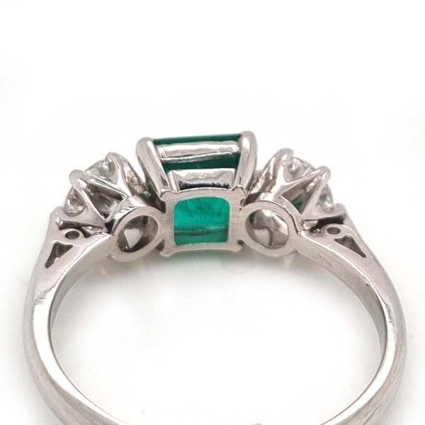 Art Deco Colombian Emerald and Diamond Trilogy Three Stone Engagement Ring, 1.25ct octagonal step-cut Colombian emerald flanked by 1ct old European transition cut diamonds in platinum