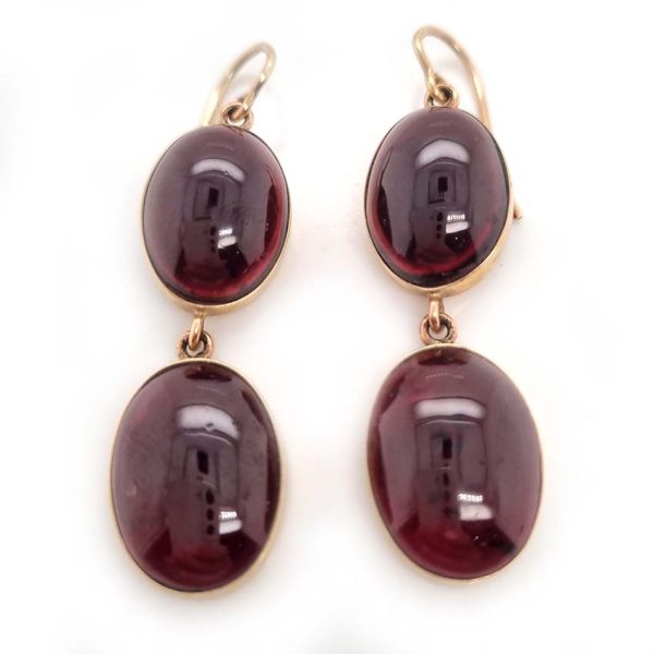 Vintage Cabochon Garnet Drop Earrings, two oval cabochon-cut garnets set in yellow gold. Secured with shepherd hook fittings. Circa 1970s