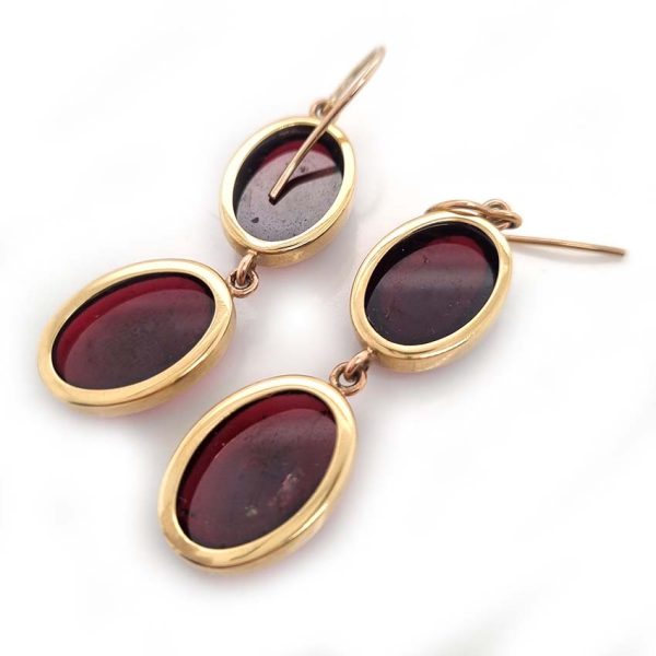 Vintage Cabochon Garnet Drop Earrings, two oval cabochon-cut garnets set in yellow gold. Secured with shepherd hook fittings. Circa 1970s
