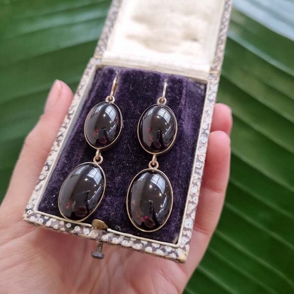 Vintage Cabochon Garnet Drop Earrings, two oval cabochon-cut garnets set in yellow gold. Secured with shepherd hook fittings. Circa 1970s
