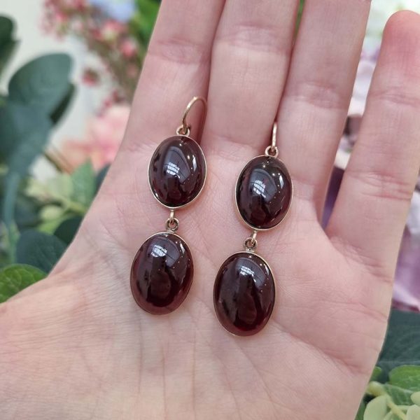 Vintage Cabochon Garnet Drop Earrings, two oval cabochon-cut garnets set in yellow gold. Secured with shepherd hook fittings. Circa 1970s