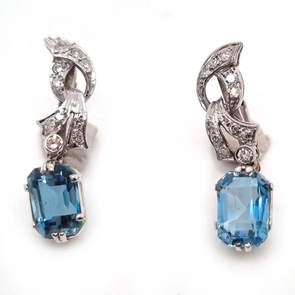 Art Deco Aquamarine and Diamond Drop Earrings, emerald-shaped step-cut aquamarines are suspended from diamond set tops in white gold. Circa 1920
