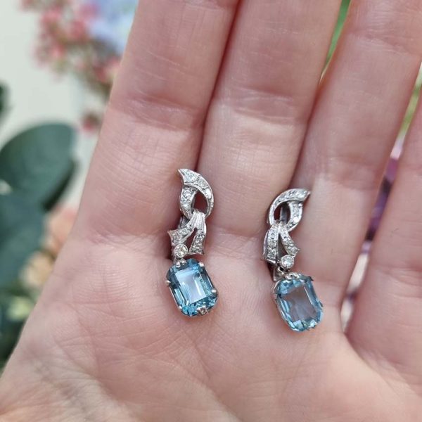 Art Deco Aquamarine and Diamond Drop Earrings, emerald-shaped step-cut aquamarines are suspended from diamond set tops in white gold. Circa 1920