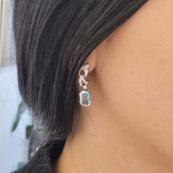 Art Deco Aquamarine and Diamond Drop Earrings, emerald-shaped step-cut aquamarines are suspended from diamond set tops in white gold. Circa 1920