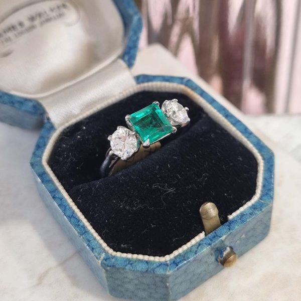 Art Deco Colombian Emerald and Diamond Trilogy Three Stone Engagement Ring, 1.25ct octagonal step-cut Colombian emerald flanked by 1ct old European transition cut diamonds in platinum