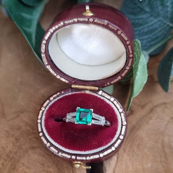 0.63ct Art Deco Colombian Emerald and Baguette Diamond Engagement Ring in Platinum, baguette diamond split shoulders to marquise diamond edges. Circa 1920