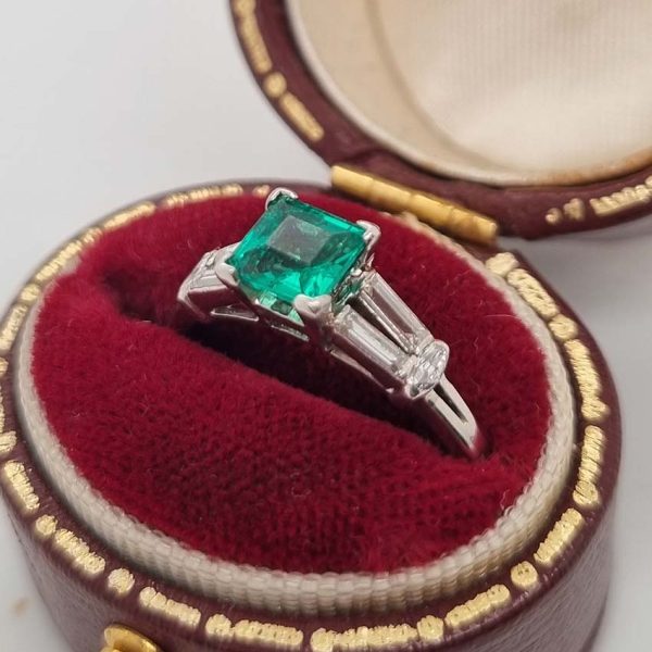 0.63ct Art Deco Colombian Emerald and Baguette Diamond Engagement Ring in Platinum, baguette diamond split shoulders to marquise diamond edges. Circa 1920