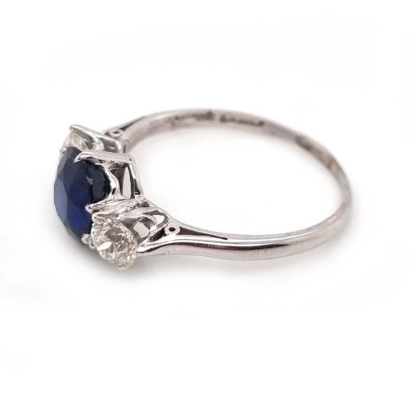 Art Deco 1.69ct Sapphire and Diamond Trilogy Three Stone Engagement Ring in Platinum, 1.69ct oval cushion-shaped Royal blue sapphire flanked by 0.60cts old mine-cut diamonds
