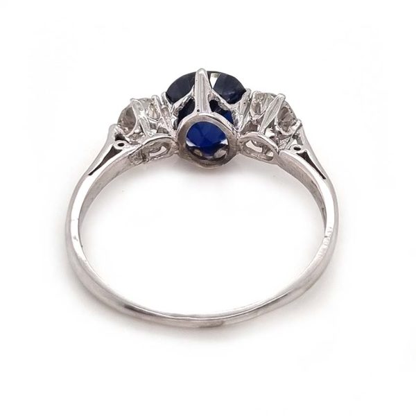 Art Deco 1.69ct Sapphire and Diamond Trilogy Three Stone Engagement Ring in Platinum, 1.69ct oval cushion-shaped Royal blue sapphire flanked by 0.60cts old mine-cut diamonds