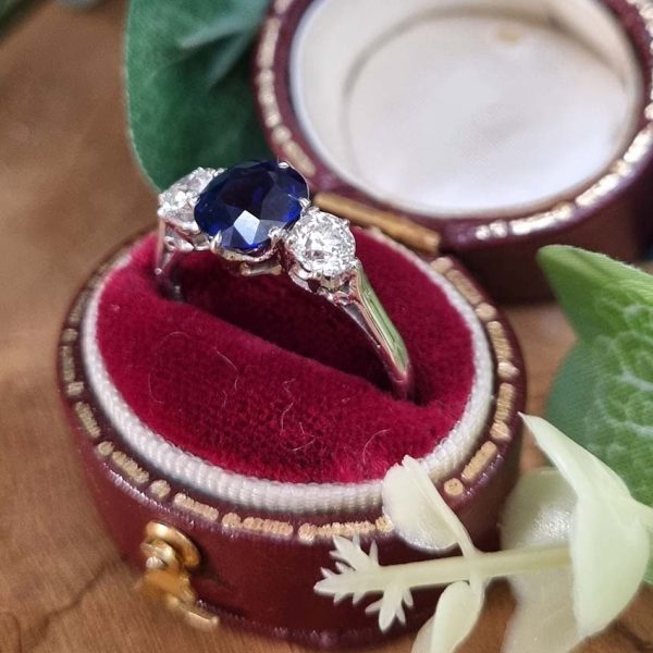 Art Deco 1.69ct Sapphire and Diamond Trilogy Three Stone Engagement Ring in Platinum, 1.69ct oval cushion-shaped Royal blue sapphire flanked by 0.60cts old mine-cut diamonds