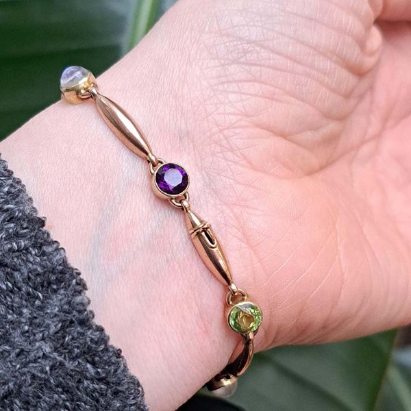 Edwardian Antique Suffragette Peridot and Amethyst Bracelet, 15ct yellow gold bracelet set with gemstones symbolic of the suffragette movement; moonstone, peridot and amethyst