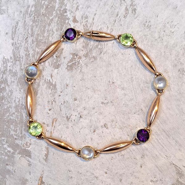 Edwardian Antique Suffragette Peridot and Amethyst Bracelet, 15ct yellow gold bracelet set with gemstones symbolic of the suffragette movement; moonstone, peridot and amethyst