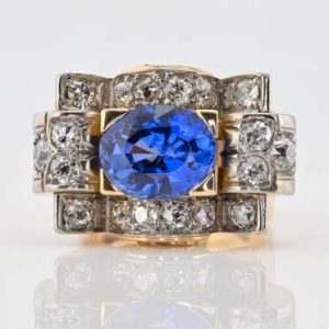 Art Deco 5.60ct Verneuil Sapphire and 3.20ct Diamond Tank Ring, 5.60ct oval royal blue lab made Verneuil sapphire within 3.20ct surround of old mine-cut diamonds in 18ct yellow gold geometric design. Circa 1925