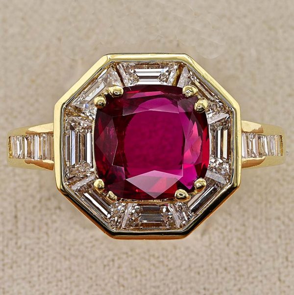 Vintage 1.50ct Ruby and 1.60cts F VVS Diamond Cluster Engagement Ring, cushion-shaped ruby surrounded by trapezoid diamonds in octagonal design in 18ct yellow gold with tapering baguette-cut diamonds to the shoulders. Circa 1970