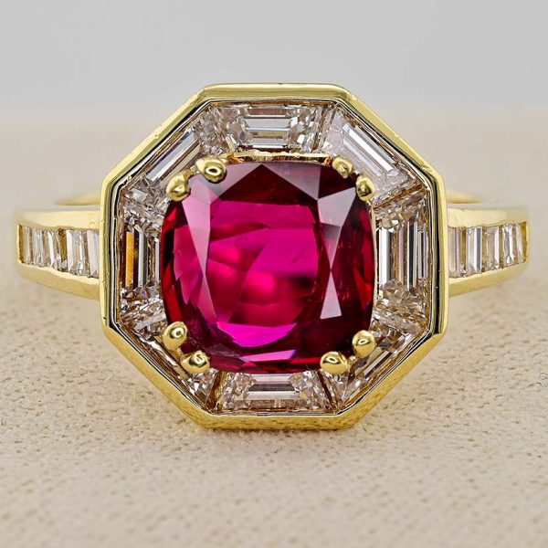 Vintage 1.50ct Ruby and 1.60cts F VVS Diamond Cluster Engagement Ring, cushion-shaped ruby surrounded by trapezoid diamonds in octagonal design in 18ct yellow gold with tapering baguette-cut diamonds to the shoulders. Circa 1970