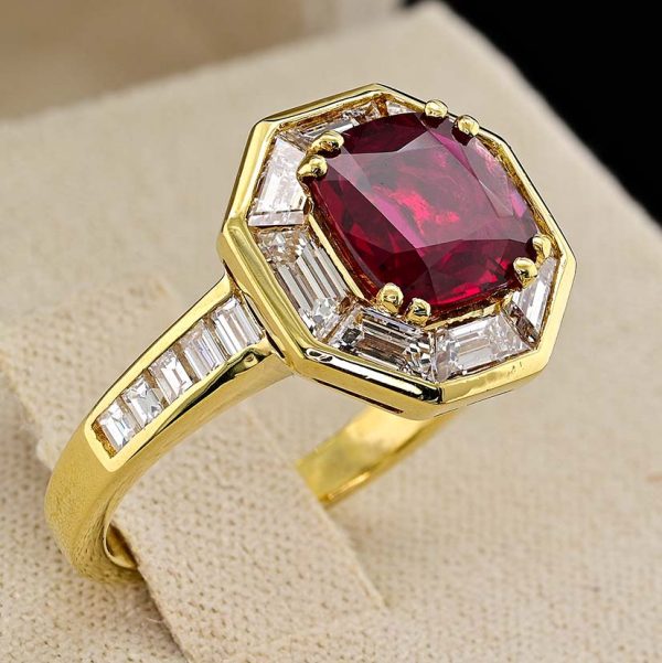 Vintage 1.50ct Ruby and 1.60cts F VVS Diamond Cluster Engagement Ring, cushion-shaped ruby surrounded by trapezoid diamonds in octagonal design in 18ct yellow gold with tapering baguette-cut diamonds to the shoulders. Circa 1970
