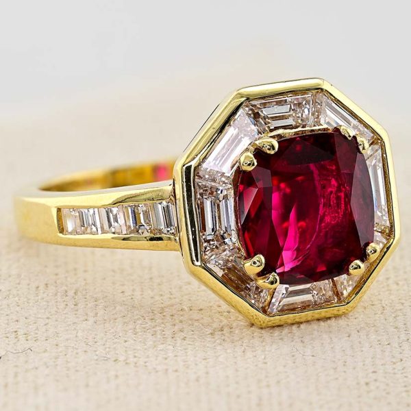Vintage 1.50ct Ruby and 1.60cts F VVS Diamond Cluster Engagement Ring, cushion-shaped ruby surrounded by trapezoid diamonds in octagonal design in 18ct yellow gold with tapering baguette-cut diamonds to the shoulders. Circa 1970