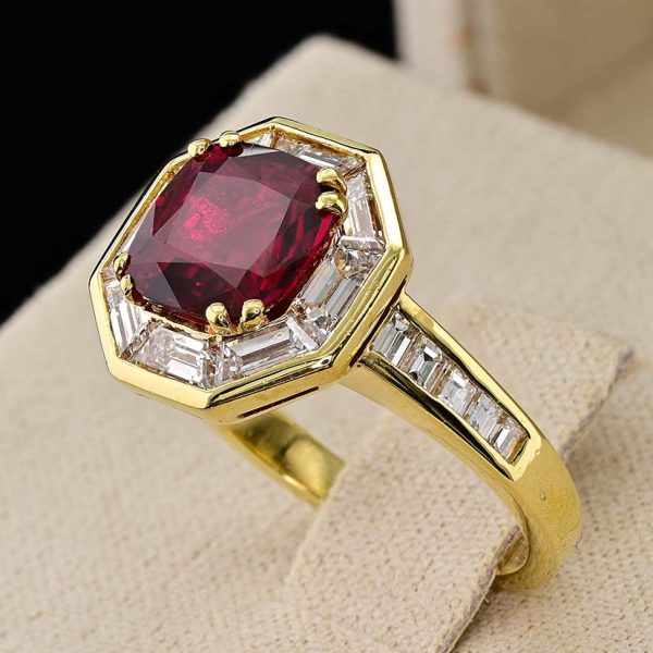 Vintage 1.50ct Ruby and 1.60cts F VVS Diamond Cluster Engagement Ring, cushion-shaped ruby surrounded by trapezoid diamonds in octagonal design in 18ct yellow gold with tapering baguette-cut diamonds to the shoulders. Circa 1970