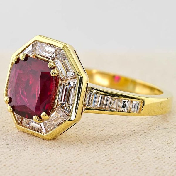 Vintage 1.50ct Ruby and 1.60cts F VVS Diamond Cluster Engagement Ring, cushion-shaped ruby surrounded by trapezoid diamonds in octagonal design in 18ct yellow gold with tapering baguette-cut diamonds to the shoulders. Circa 1970