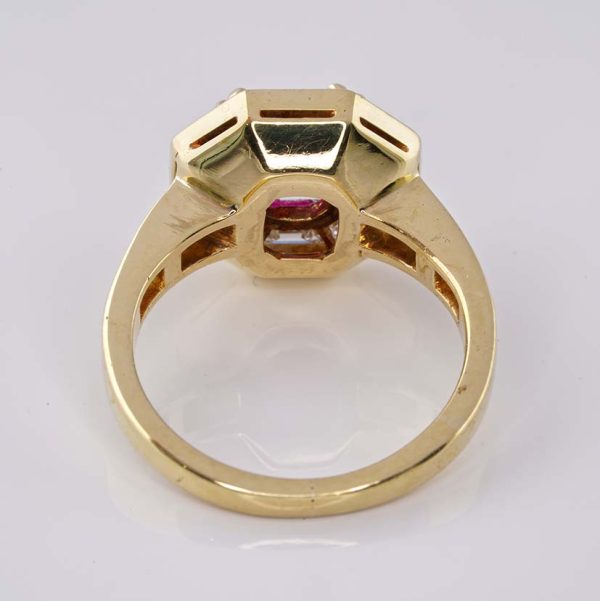 Vintage 1.50ct Ruby and 1.60cts F VVS Diamond Cluster Engagement Ring, cushion-shaped ruby surrounded by trapezoid diamonds in octagonal design in 18ct yellow gold with tapering baguette-cut diamonds to the shoulders. Circa 1970
