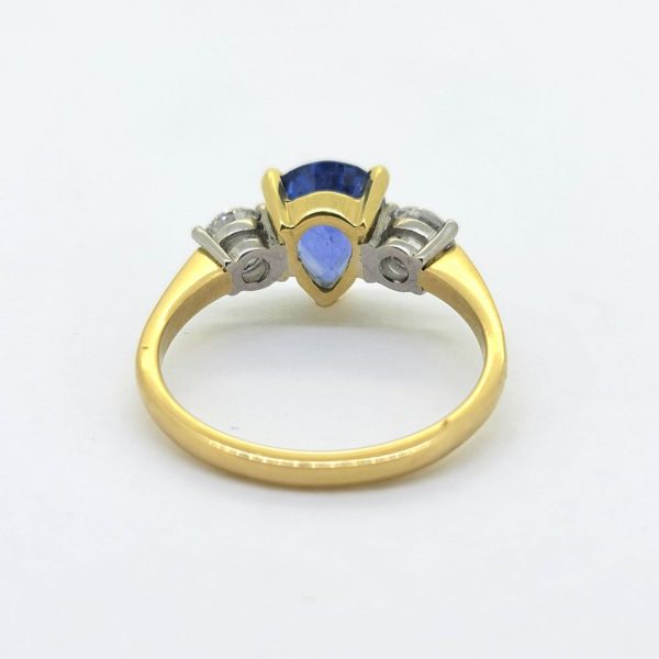 2.2ct Pear Cut Sapphire and Diamond Trilogy Three Stone Engagement Ring, 2.20 carat pear-shaped blue sapphire flanked by 0.95cts round brilliant-cut diamonds in platinum to an 18ct yellow gold band